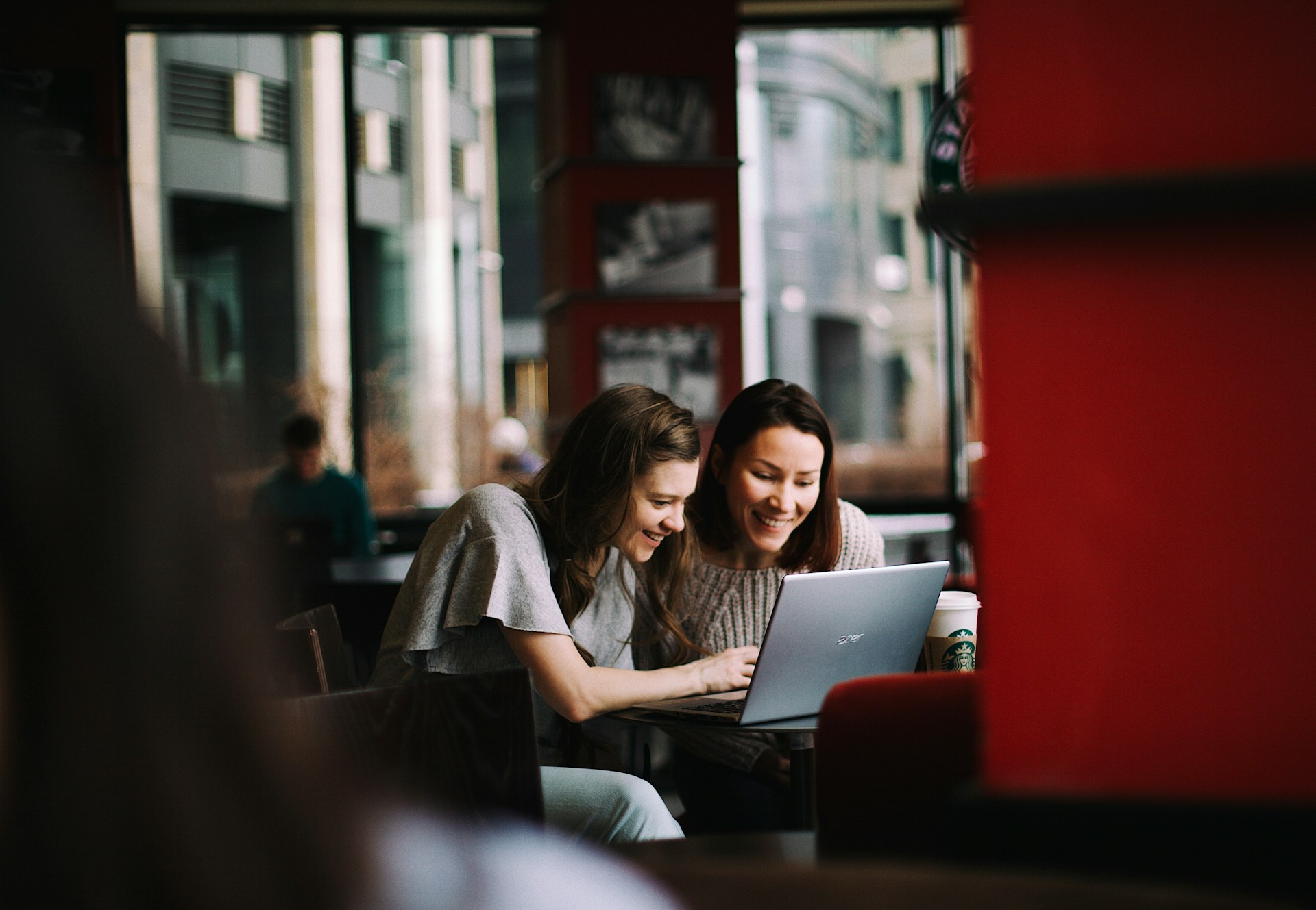 Woman in white shirt using MacBook